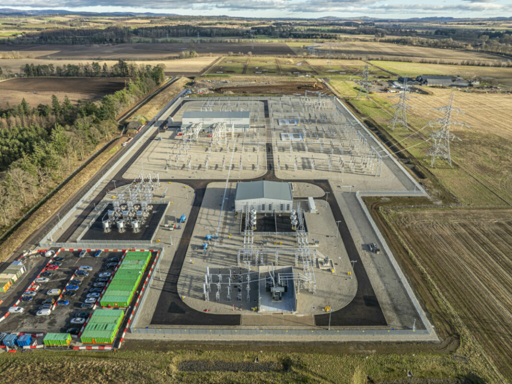 Aerial shot of a substation in a field