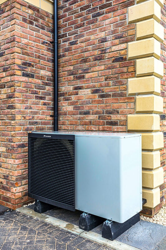 EDF Heat Pump mounted against a brick wall