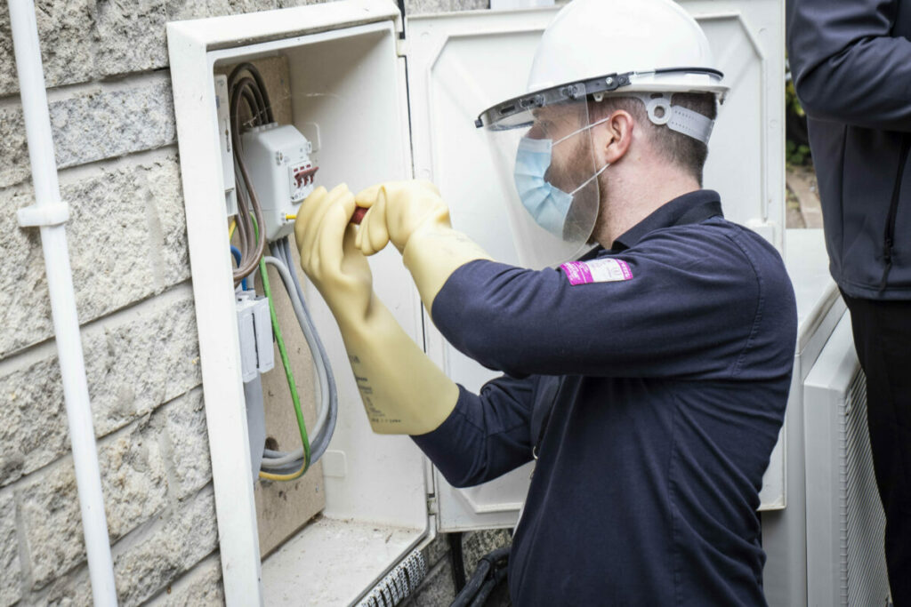 SMS Worker Installing Smart Meter