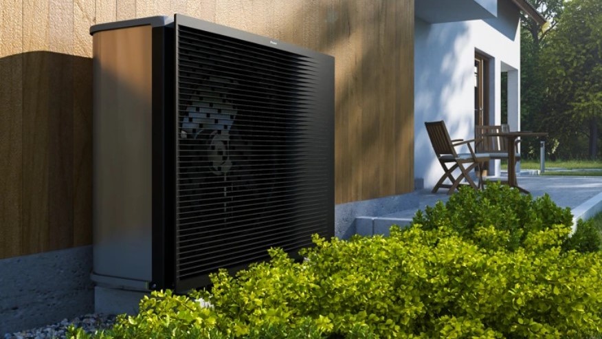 A Daikin heat pump installed against a wooden wall