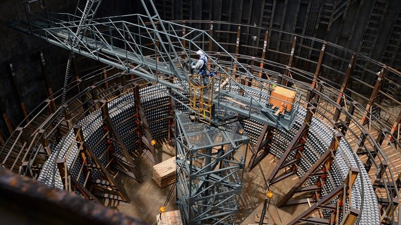 A worker constructs HVDC cables at a large facility