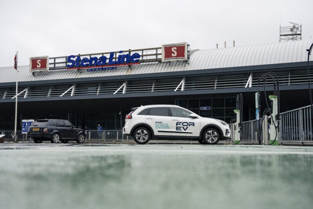 An EV with the FOR EV logo sits in front of a Stena Line port in the rain