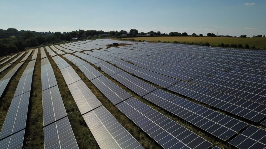 Long lines of solar panels on a solar farm