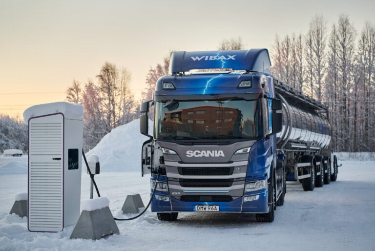 An electric HGV charges up in the snow