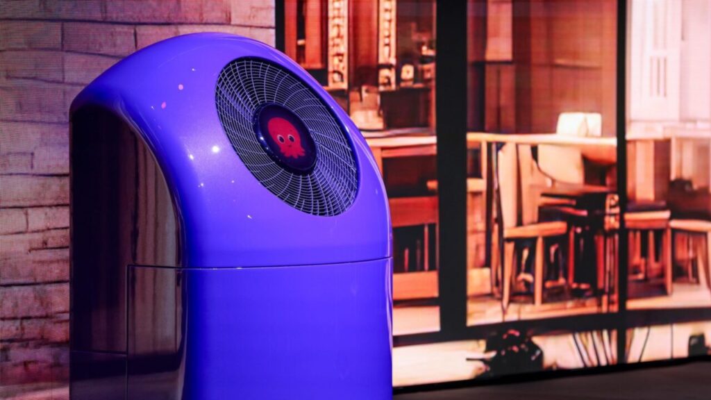 A heat pump branded with the Octopus logo outside a home at night