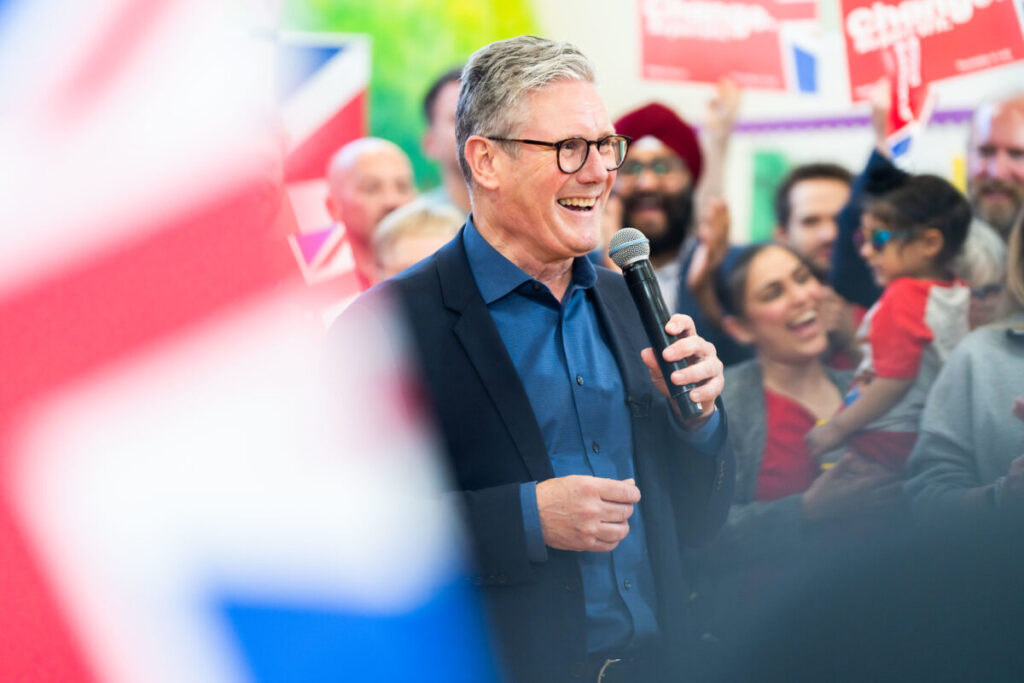 Keir Starmer smiling in a crowd on his election campaign.