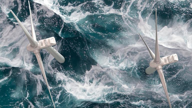 Two offshore wind turbines viewed from above in a choppy blue sea