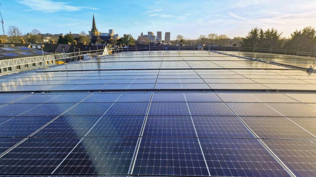a data centre with solar panels on the roof and a city in the background