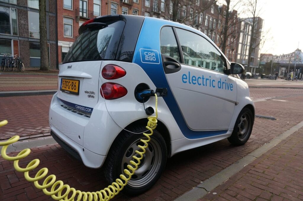 small EV plugged in to charge.