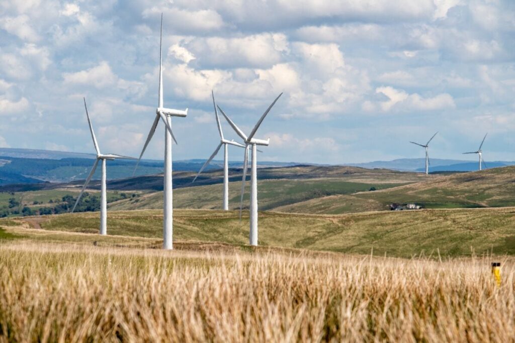 Wind turbines in a yellow grassy field