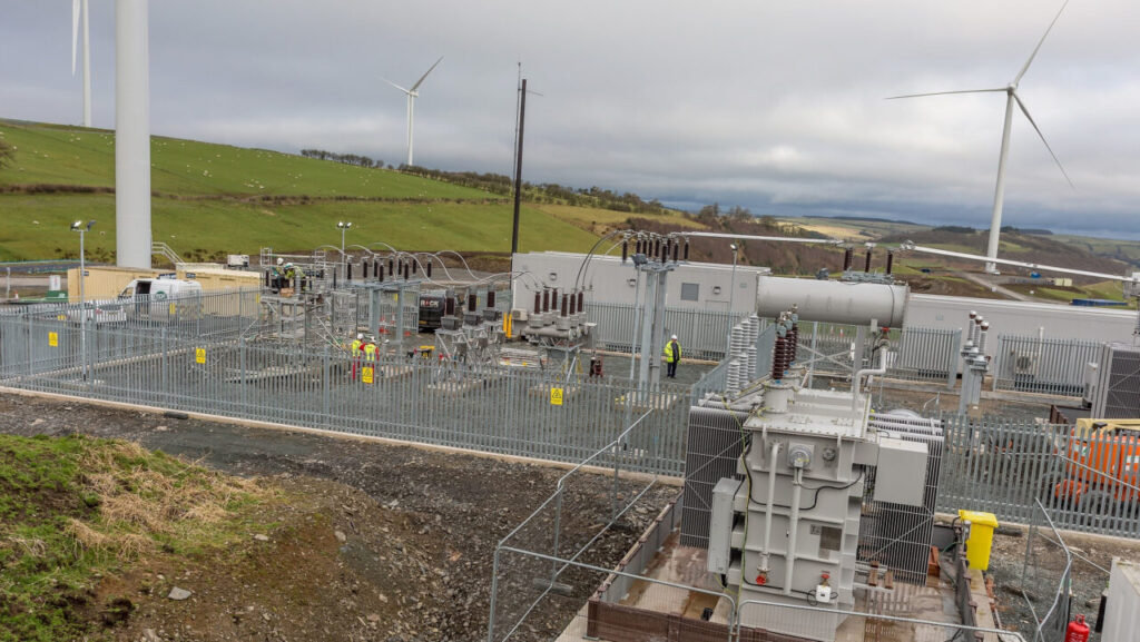 An electricity substation next to wind turbines