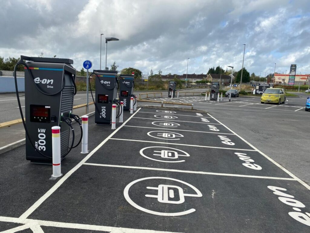 EV chargers in a row, with the e.on logo on the ground in front of each