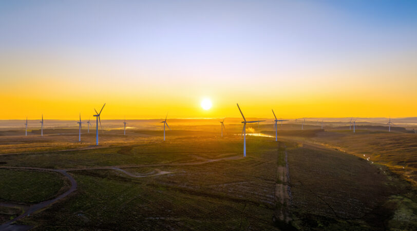 the kype muir onshore wind farm at sunset