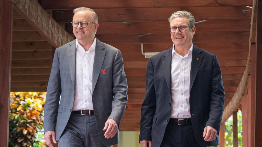 L-R: Anthony Albanese and Keir Starmer walk next to eachother