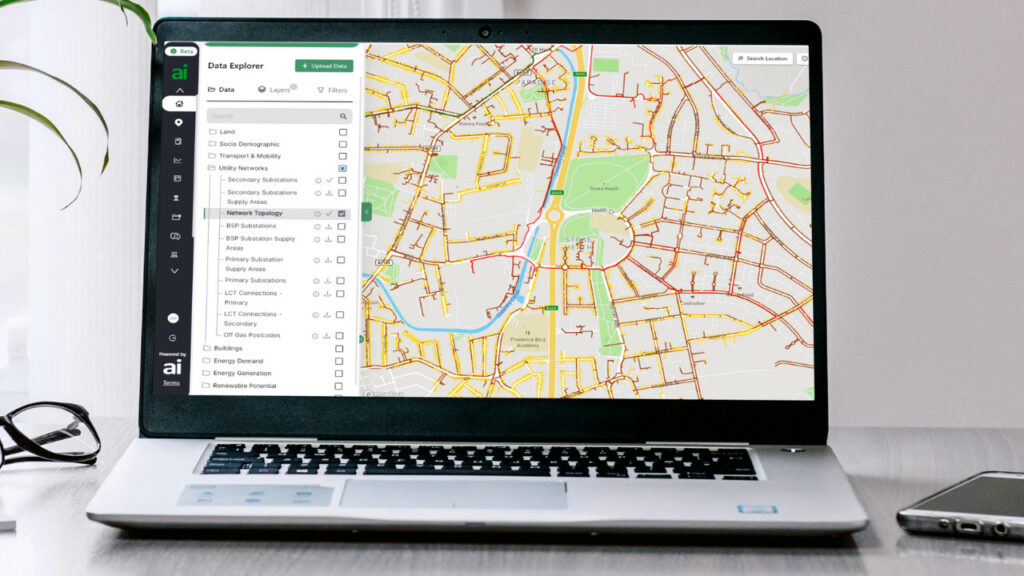 A laptop displays a grid connection software package on the screen