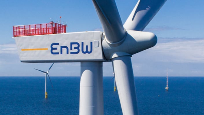 a close up of a wind turbine with the EnBW logo