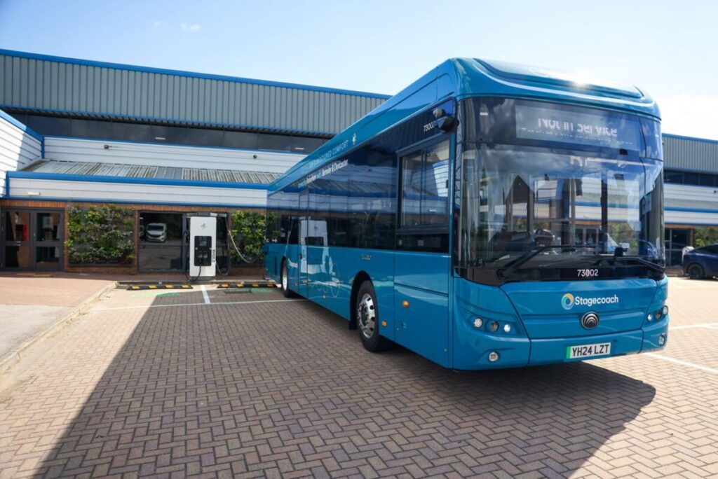 an electric bus next to an EV charger