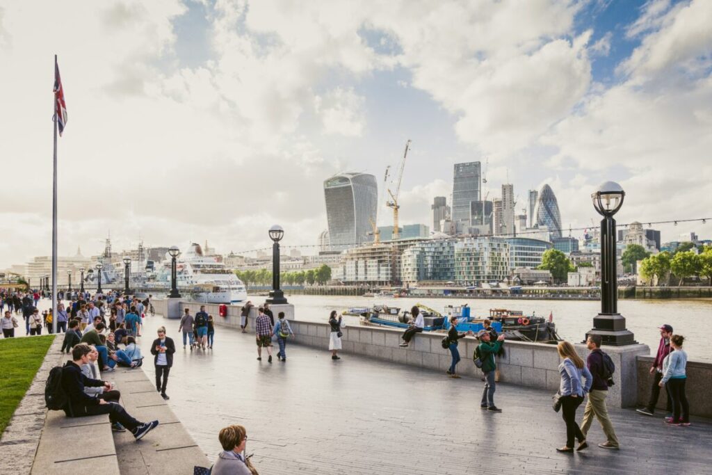 a view of the river Thames with several iconic modern buildings behind it