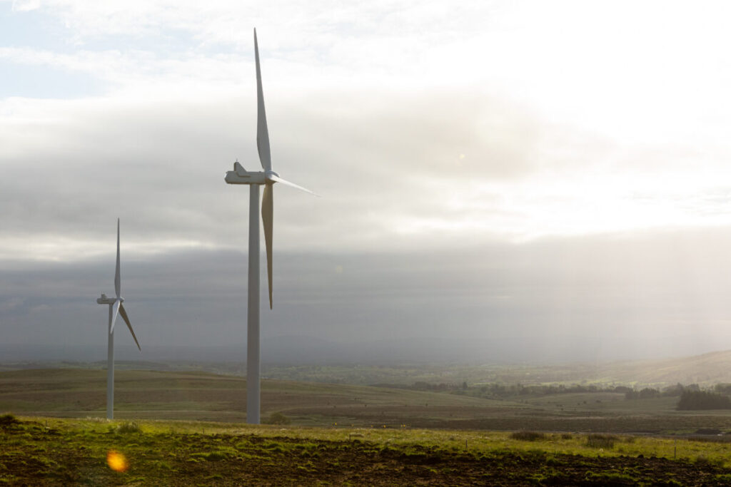 a wind turbine in front of a cloudy grey sky