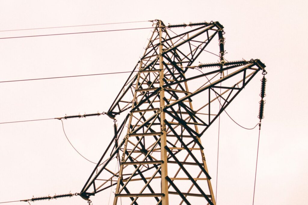 a rusty pylon against a white sky