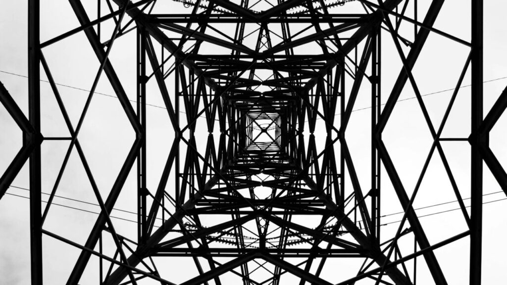 an electric pylon shot from underneath in black and white