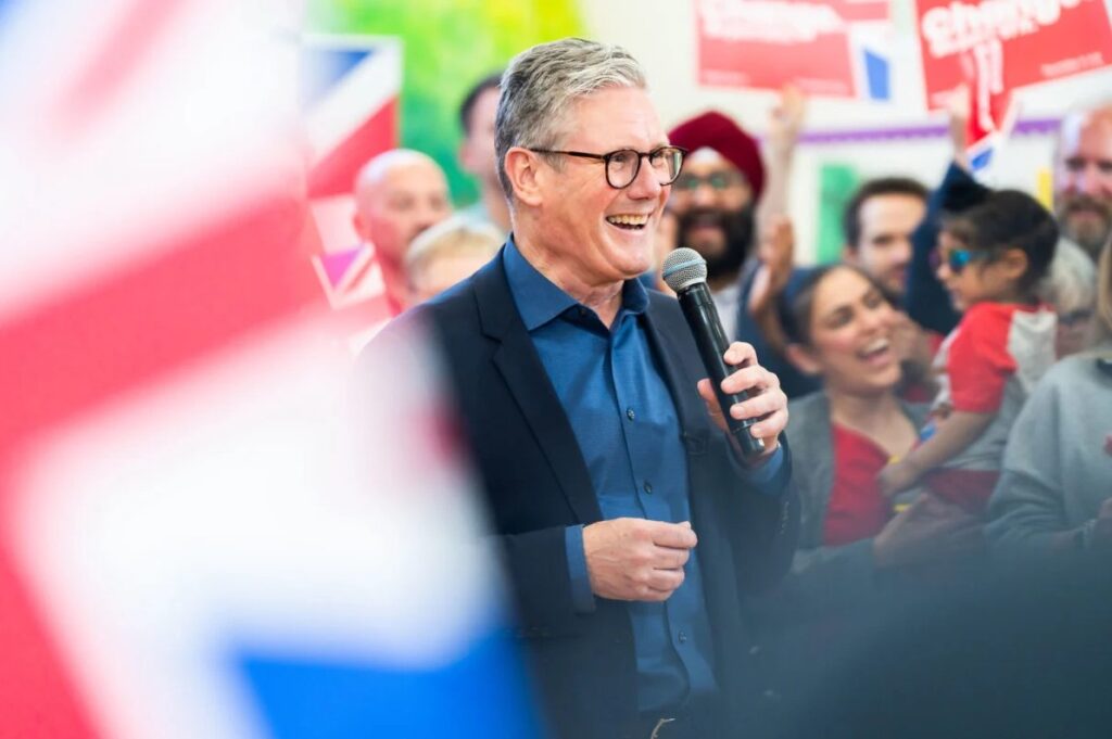 Keir Starmer smiling in a crowd on his election campaign.