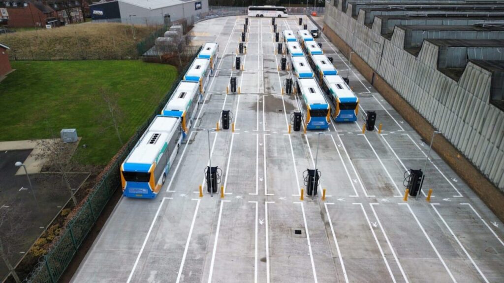 a series of electric buses plugged in to charge