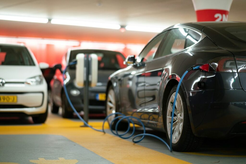evs in a public car park plugged in to charge