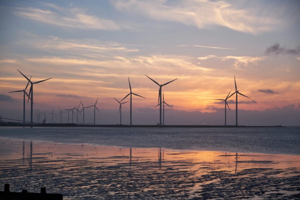 offshore wind turbines at sunset