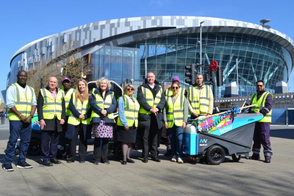 members of haringey council stand by a new street sweeper