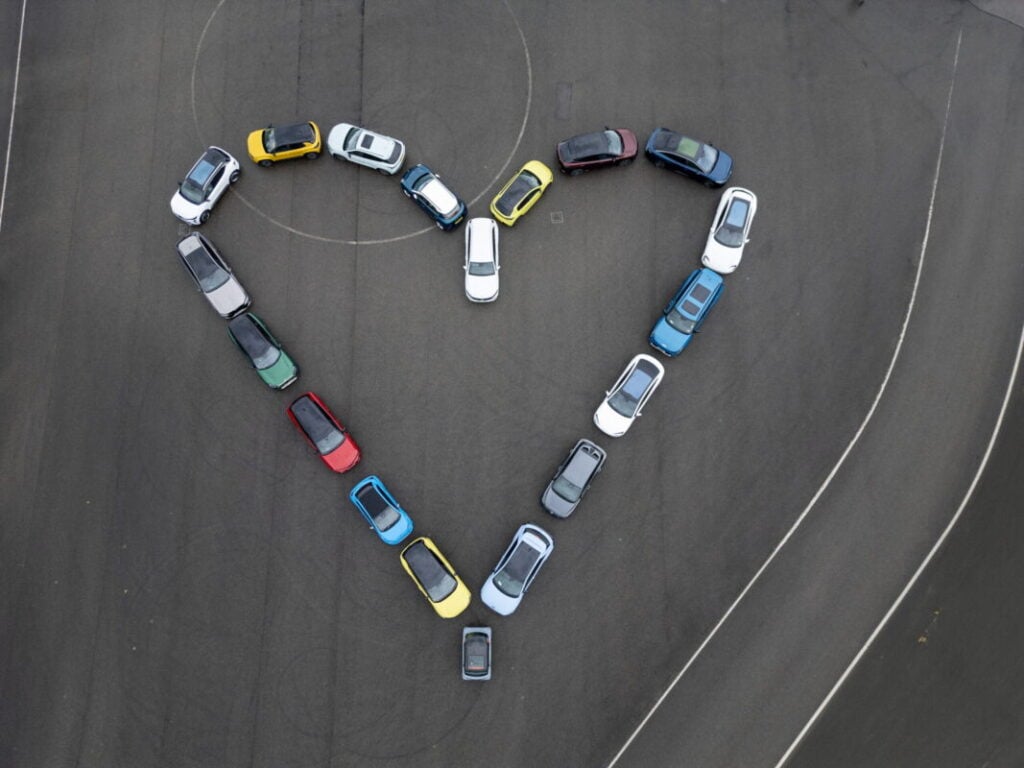 Cars in a heart shape shot from above