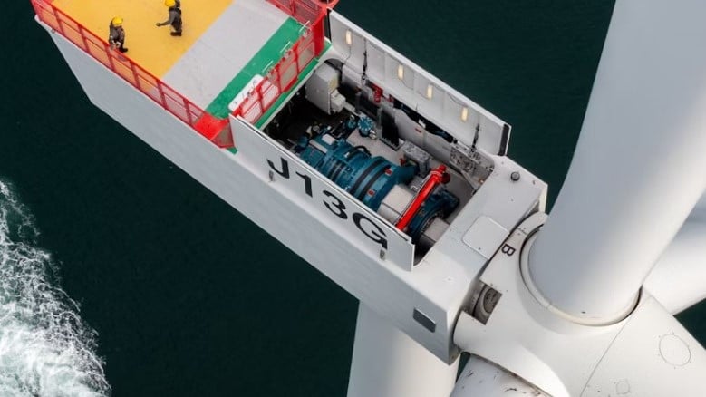 a close up of the inside of an offshore wind turbine with water below it.