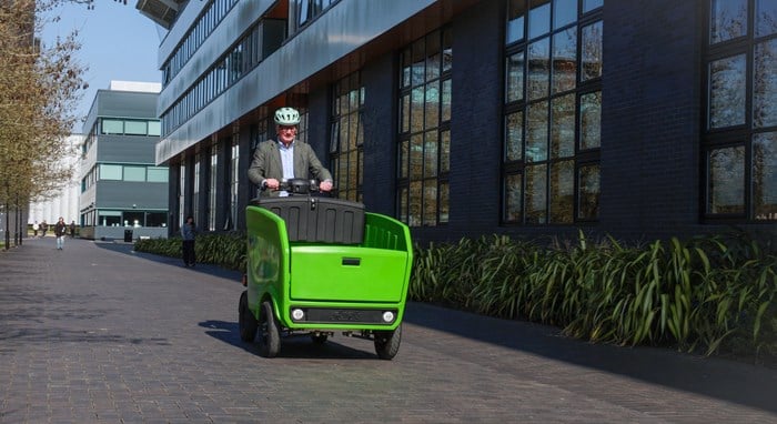 a white man on a green delivery vehicle