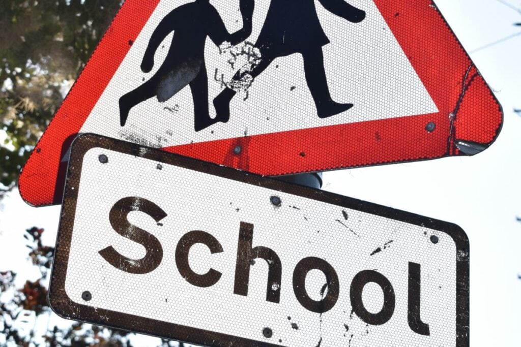 a close up on a school traffic warning sign