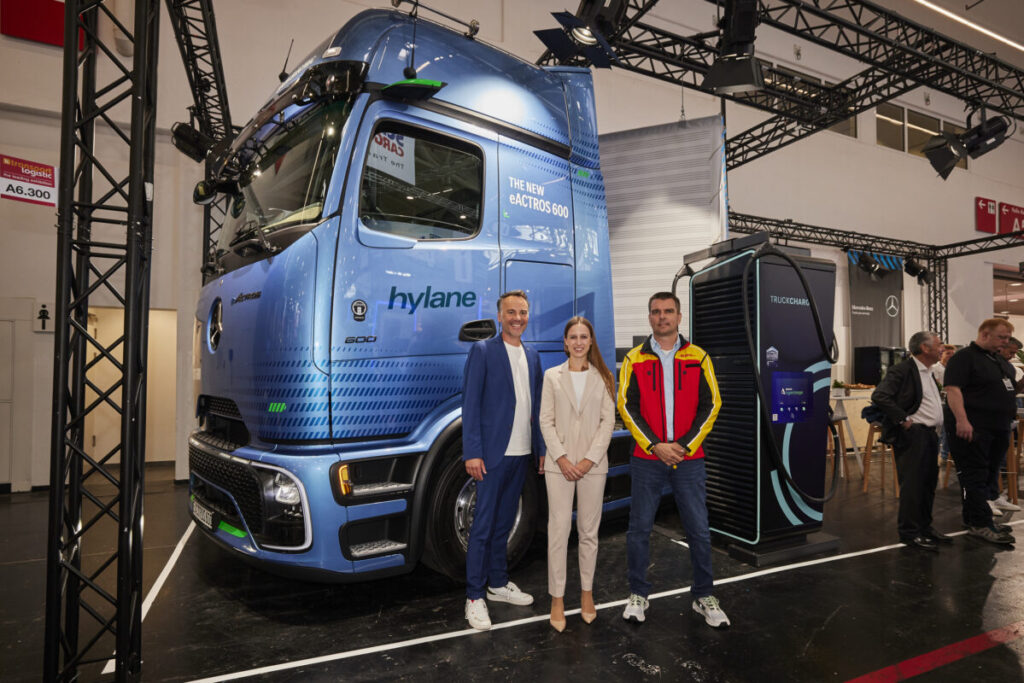 Daimler, DHL, and hylane representatives with one of the new trucks.