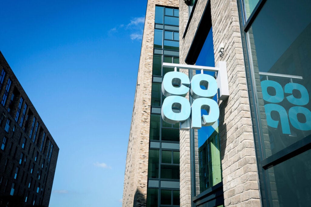 a blue co-op sign hanging off a building