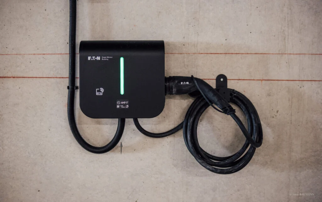 an EV charger on a concrete wall
