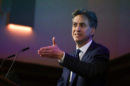 ed Miliband stands by a podium