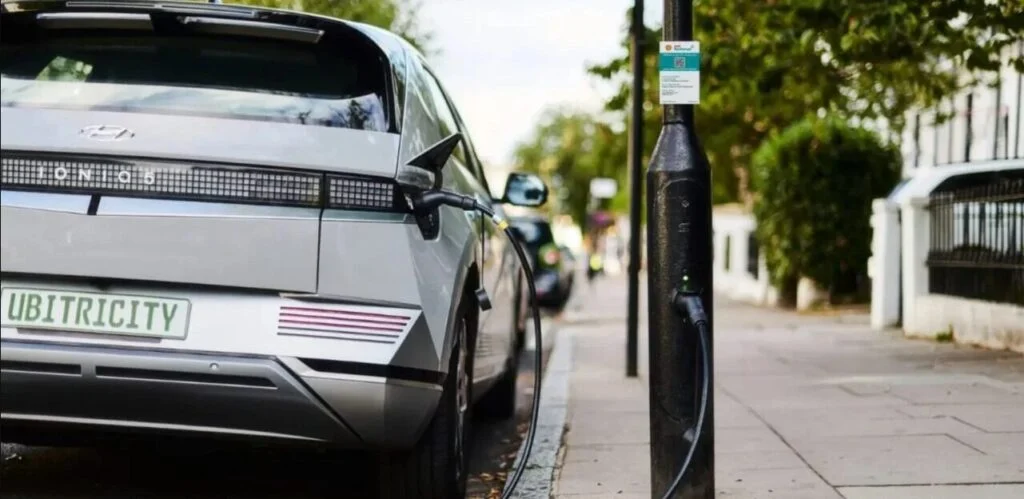 an ev plugged into a lamppost charger