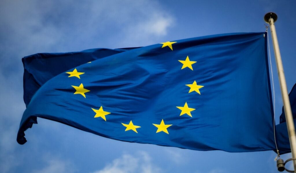 an EU flag flying in a blue sky