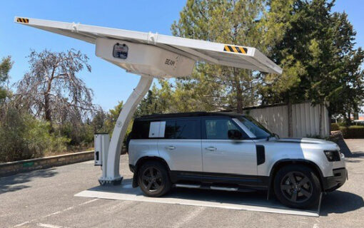 An electric SUV charges under a solar-powered EV charger