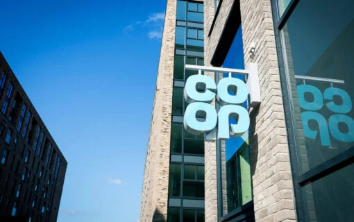 a blue co-op sign hanging off a building