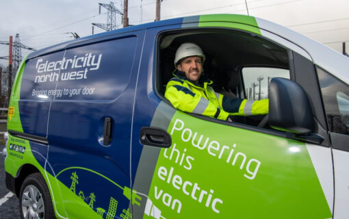 A man sits in an Electricity North West branded van