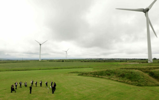 The Orchestra for the Earth performs by wind turbines at Delabole wind farm. Image: Emily Whitfield-Wicks.