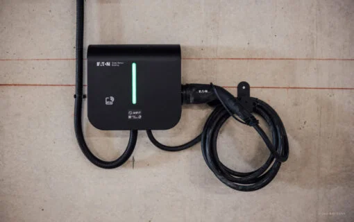 an EV charger on a concrete wall