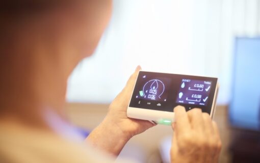 a woman looks at a smart meter