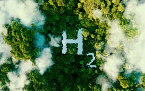 Image of chemical symbol for Hydrogen viewed from above among trees and cloud