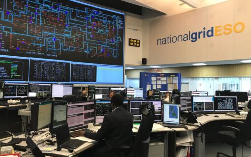 Desks and large walls of computer monitors with complex data mapping inside National Grid ESO's Electricity National Control Centre