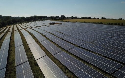 Long lines of solar panels on a solar farm