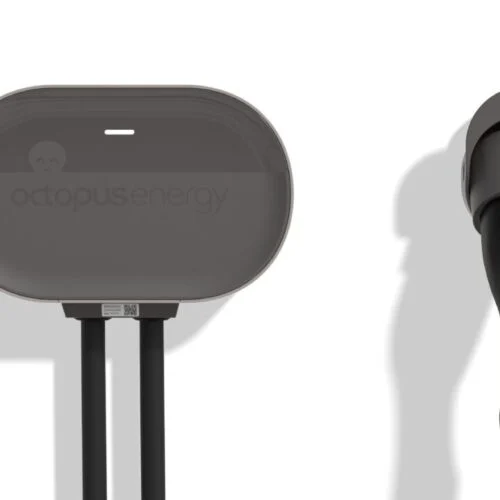 a white wall with a black EV charger on it